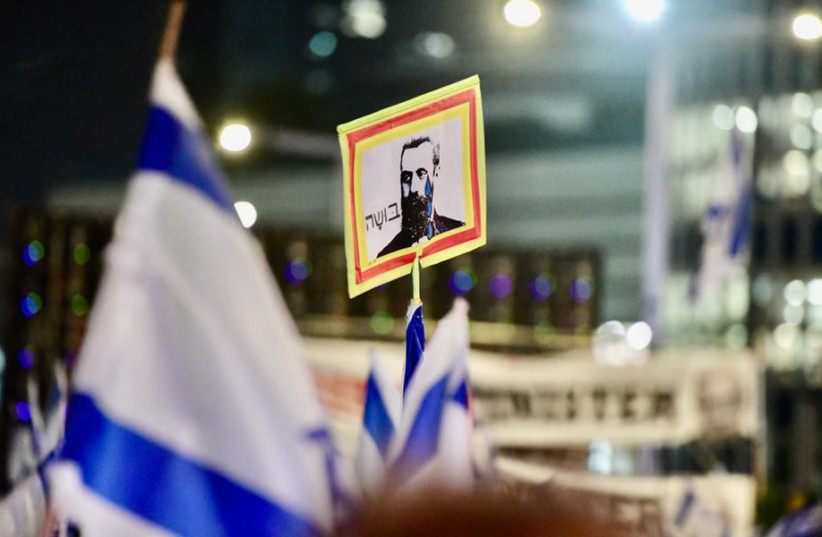  Anti-judicial reform protestor holding a sign featuring Theodore Herzl crying, labled with ''shame'' in Hebrew, September 30, 2023. (credit: AVSHALOM SASSONI)