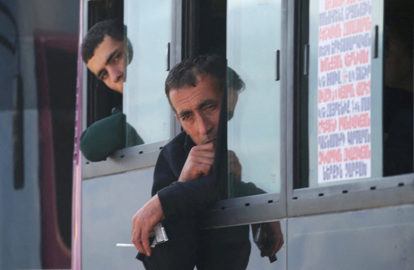  Refugees from Nagorno-Karabakh region sit in a bus upon their arrival in the border village of Kornidzor, Armenia, September 29, 2023. (credit: REUTERS/IRAKLI GEDENIDZE)