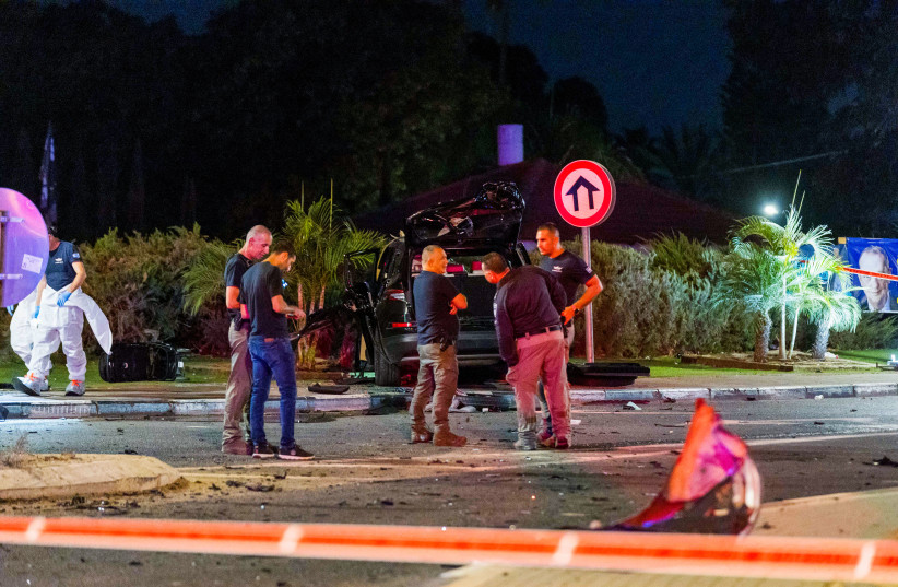  Police officers at the scene where one person was killed and two were injured in a car bomb assassination in Moshav Hatsav, October 1, 2023.  (credit: LIRON MOLDOVAN/FLASH 90)