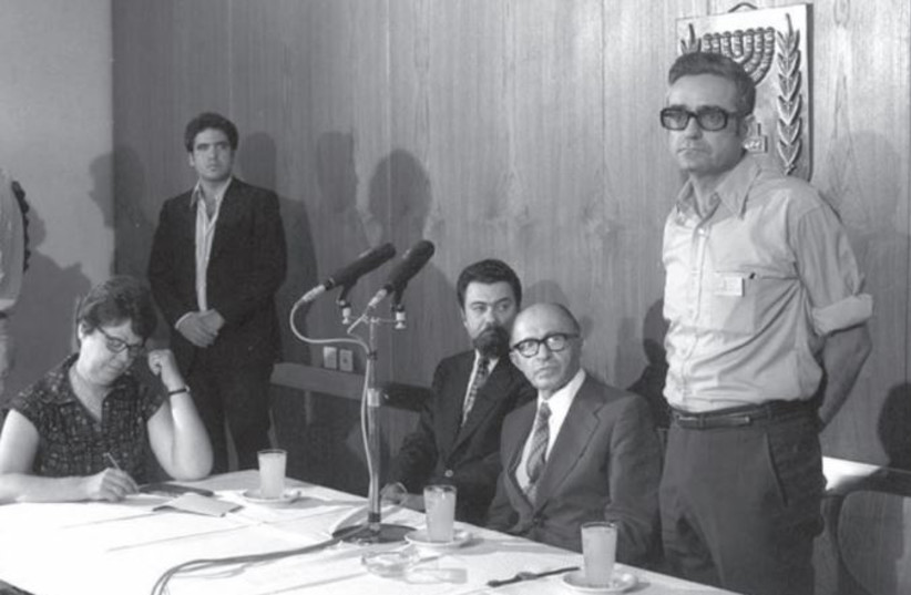  Meron Medzine, director of the Government Press Office, at a news conference with then-prime minister Menachem Begin. (credit: DAVID ELDAN/GPO)
