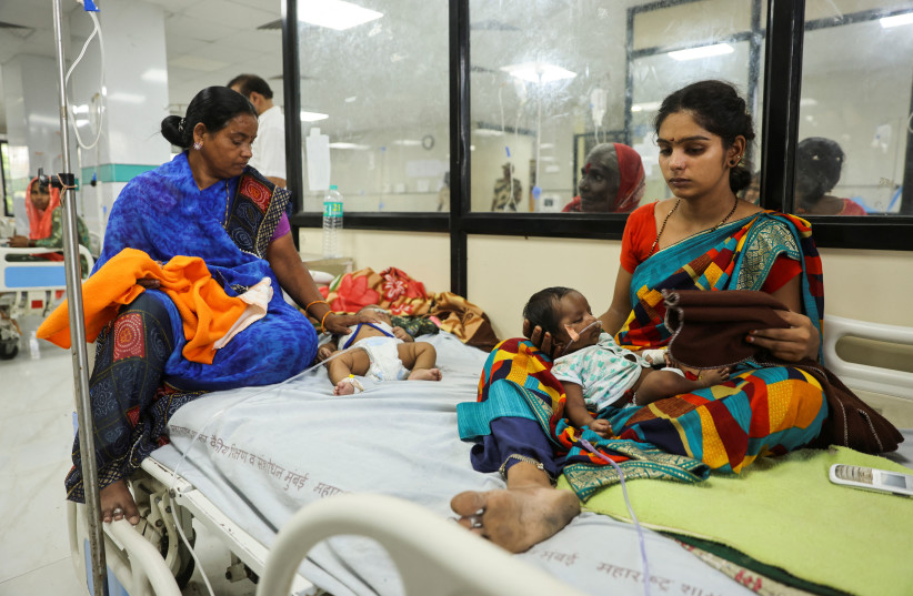  Laxmi Ujvalharangwari holds her one month old child Rudra, after he was diagnosed with pneumonia inside the pediatric ward of the Shankarrao Chavan Government Medical College and Hospital in Nanded, India, October 3, 2023 (credit: REUTERS/FRANCIS MASCARENHAS)