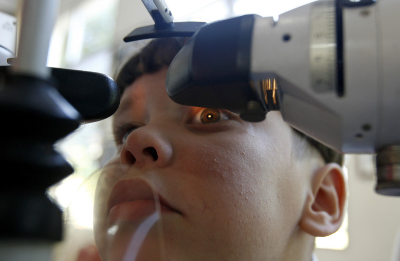  A boy with special needs looks at an image to stimulate the cornea at the ''Solidarity with Panama'' school in Havana May 15, 2008. (credit: CLAUDIA DAUT/REUTERS)