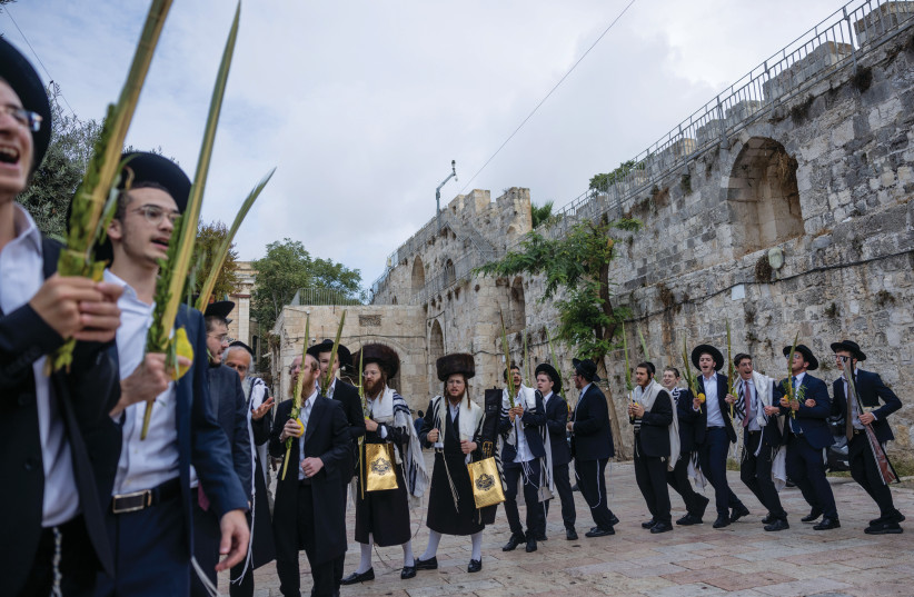  SINGING AND dancing in honor of Sukkot at the entrance to the Temple Mount compound, in Jerusalem’s Old City, Oct. 1.  (credit: Chaim Goldberg/Flash90)
