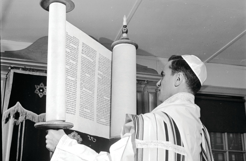  FRESH EYES: Lifting a Torah scroll at Yeshiva University in New York, 1950.  (credit: Al Barry/Three Lions/Getty Images)
