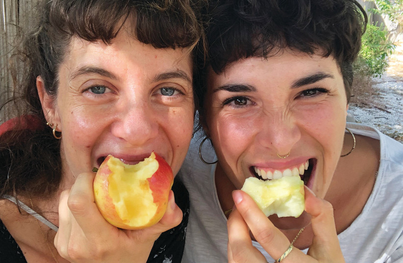  MULTIDISCIPLINARY ARTIST Ruth Hof and Food Rescuers founder Daniella Seltzer bite into a bit of goodness (credit: Nir Amit)
