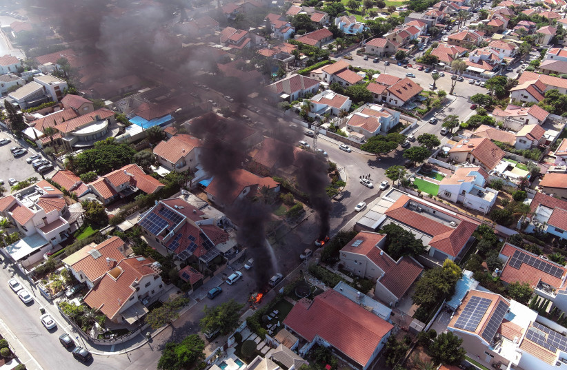 An aerial view shows vehicles on fire as rockets are launched from the Gaza Strip, in Ashkelon, southern Israel October 7, 2023. (credit: REUTERS/ILAN ROSENBERG)