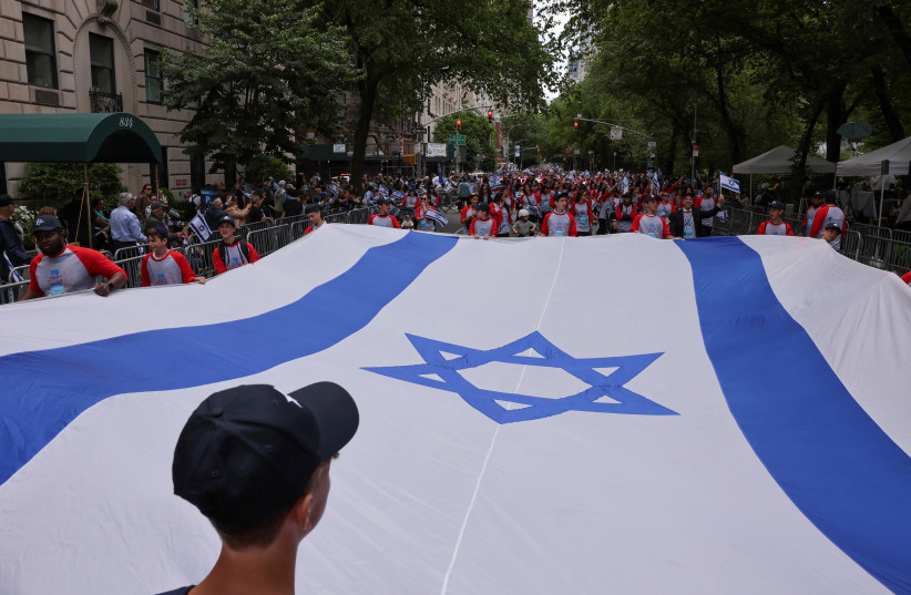  People carry an Israeli flag during the ''Celebrate Israel'' parade in New York a few months ago. (credit: REUTERS)