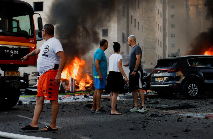 People react on the road, in the aftermath of rocket barrages that were launched from Gaza, in Ashkelon, Israel October 7, 2023.