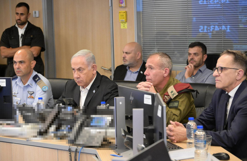   Israeli Prime Minister Benjamin Netanyahu with senior military officers in an Israeli Air Force war room, October 8, 2023. (credit: AMOS BEN-GERSHOM/GPO)