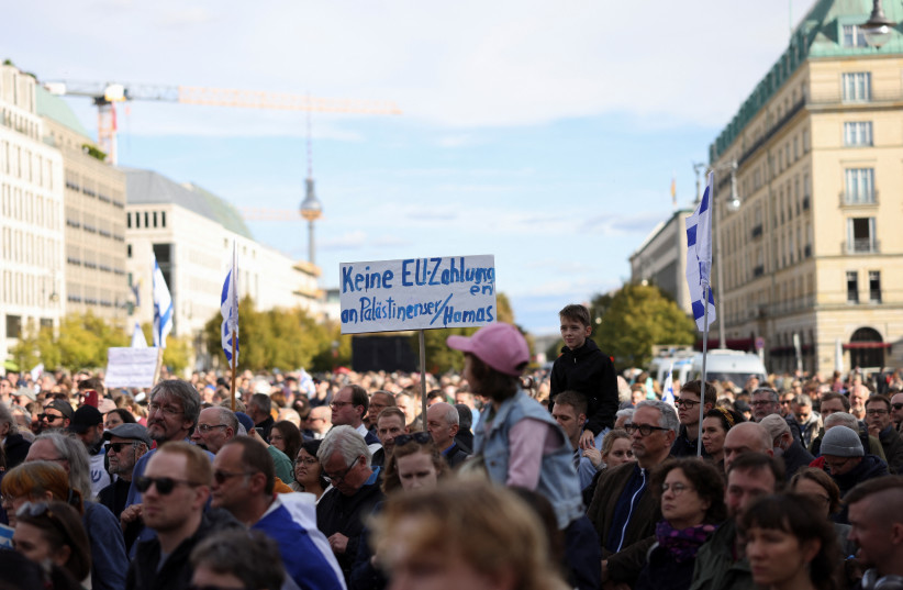  A placard reading ''No EU payments to Palestinians/Hamas'' is held as Israel supporters protest, following Hamas' biggest attack on Israel in years, next to the Brandenburg Gate, in Berlin, Germany, October 8, 2023. (credit: REUTERS/Liesa Johannssen)