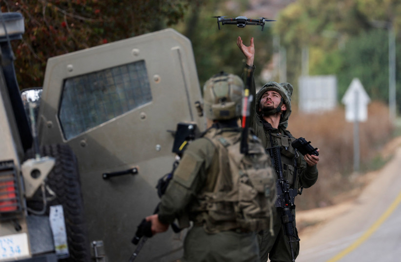  An Israeli soldier launches a remote-controlled drone as Israeli soldiers patrol near Israel's border with Lebanon, northern Israel, October 9, 2023. (credit: REUTERS/AMMAR AWAD)