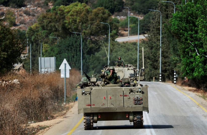  Israeli soldiers drive in Israeli Armoured Personnel Carriers (APCs) near Israel's border with Lebanon, northern Israel, October 9, 2023. (credit: REUTERS/AMMAR AWAD)