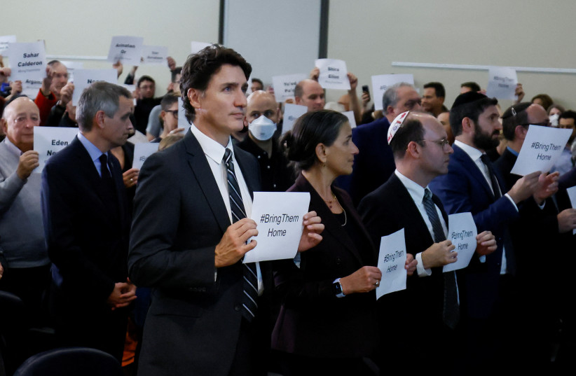  Canada's Prime Minister Justin Trudeau holds up a sign with attendees during a pro-Israel rally at the Soloway Jewish Community Centre in Ottawa, Ontario, Canada October 9, 2023.  (credit: REUTERS/BLAIR GABLE)