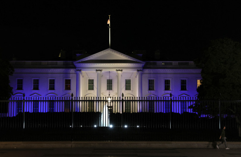 The White House is lit with the colors of the Israeli flag in Washington, US, October 9, 2023. (credit: LEAH MILLIS/REUTERS)