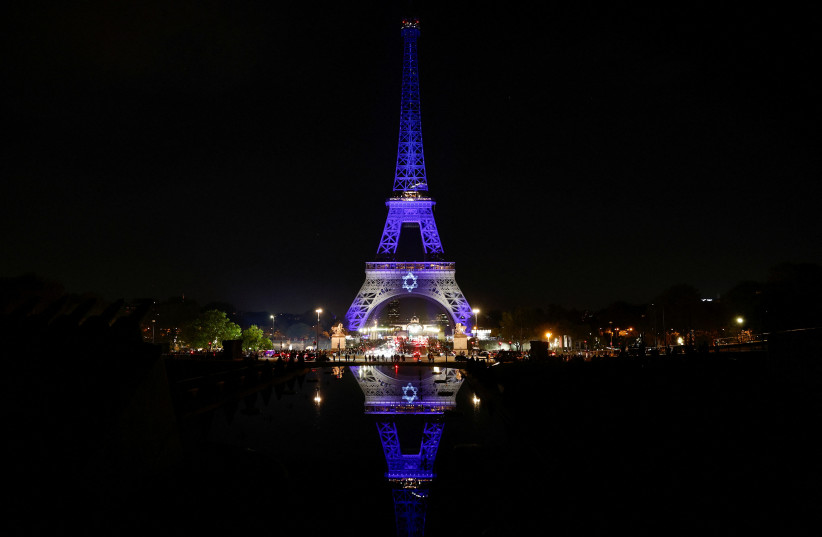  The Eiffel Tower lights up in white and blue, the colors of the Israeli flag, following Hamas's biggest attack on Israel in years, in Paris, France, October 9, 2023 (credit: REUTERS/BENOIT TESSIER)