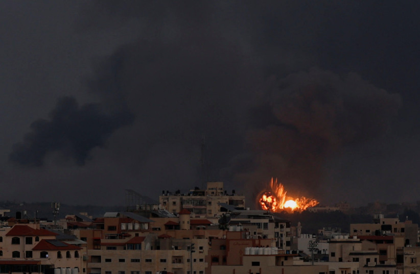  Explosions are seen, following Israeli strikes in Gaza City, October 10, 2023 (credit: REUTERS/MOHAMMED SALEM)