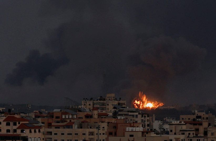 Explosions are seen, following Israeli strikes in Gaza City, October 10, 2023