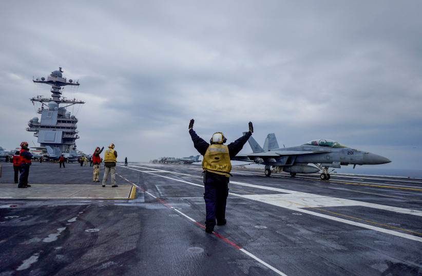  People stand onboard the American aircraft carrier USS Gerald R. Ford in the North Sea off Denmark, May 22, 2023.  (credit: Hakon Mosvold Larsen/NTB/via REUTERS)