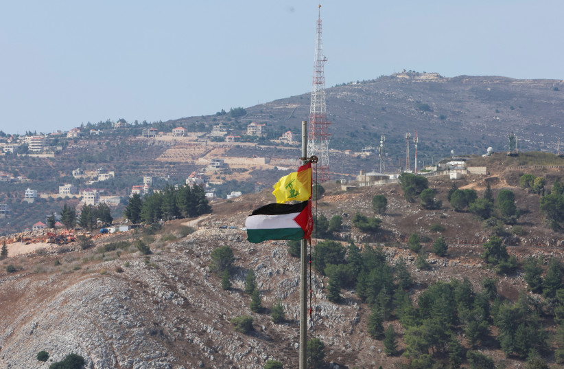  Palestinian and Hezbollah flags flutter in Khiam, near the border with Israel, in southern Lebanon October 9, 2023. (credit: REUTERS/AZIZ TAHER)