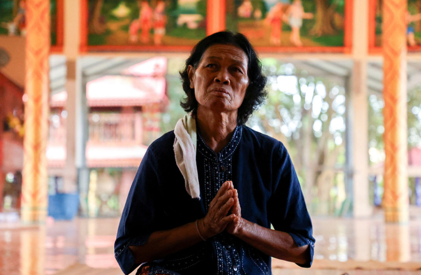  Noopar Pansa-ard, 63, prays for her son, Somkuan Pansa-ard, 39, a Thai labour who was killed in Israel in the ongoing conflict between Israel and the Palestinian Islamist group Hamas, at a temple in Kalasin province, Thailand, October 11, 2023. (credit: REUTERS/Thomas Suen)