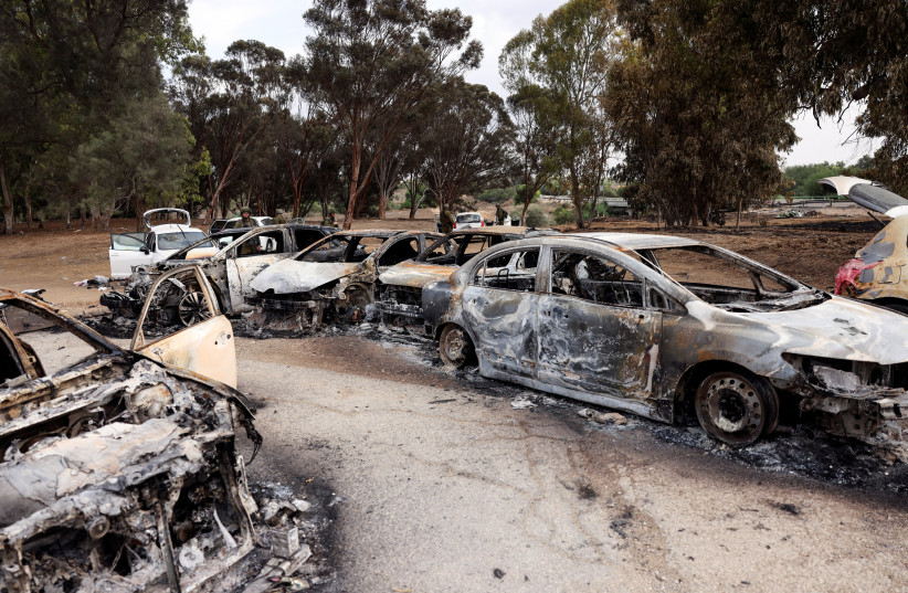  Burnt cars are abandoned in a carpark near where a festival was held before an attack by Hamas gunmen from Gaza that left at least 260 people dead, by Israel's border with Gaza in southern Israel, October 10, 2023. (credit: REUTERS/Ronen Zvulun)