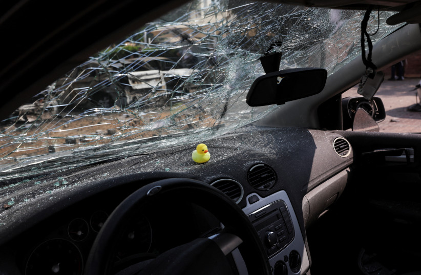 A view shows the broken windscreen of a car that was damaged when a rocket, launched from the Gaza Strip, landed in Ashkelon, southern Israel, October 11, 2023.  (credit: Violeta Santos Moura/Reuters)