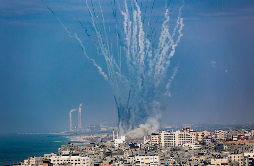  Rockets are fired from Gaza towards Israel, as it seen from Gaza City, on October 11, 2023 (credit: ATIA MOHAMMED/FLASH90)
