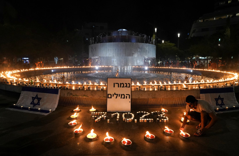  People gather and light candles to show solidarity with Israel and remember the victims following an attack by Hamas terrorists from Gaza, at Dizengoff square in Tel Aviv, Israel October 12, 2023. (credit: REUTERS/JANIS LAIZANS)