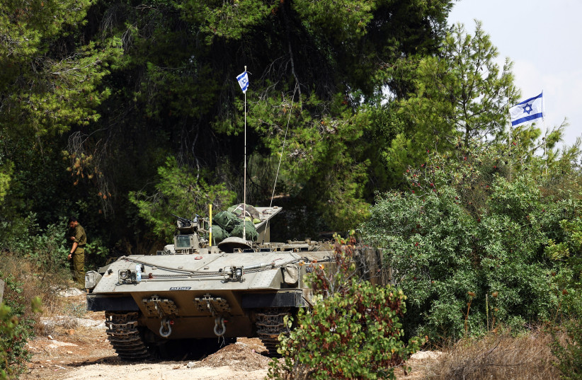  An Israeli Armored Personnel Carrier (APC) is seen at Israel's border with Lebanon as tension mounts between the countries, in northern Israel, October 11, 2023. (credit: Lisi Niesner/Reuters)