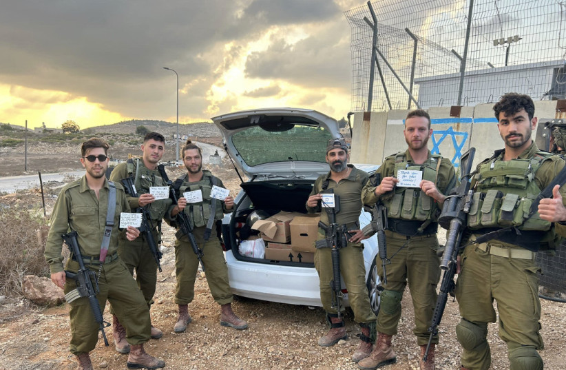  IDF soldiers are seen holding supplies sent by MASA fellows. (credit: Uriel Peizer)