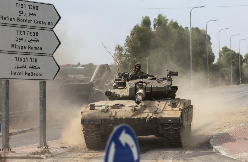  IDF SOLDIERS drive in a tank near Israel’s border with Gaza this week.  (credit: RONEN ZVULUN/REUTERS)