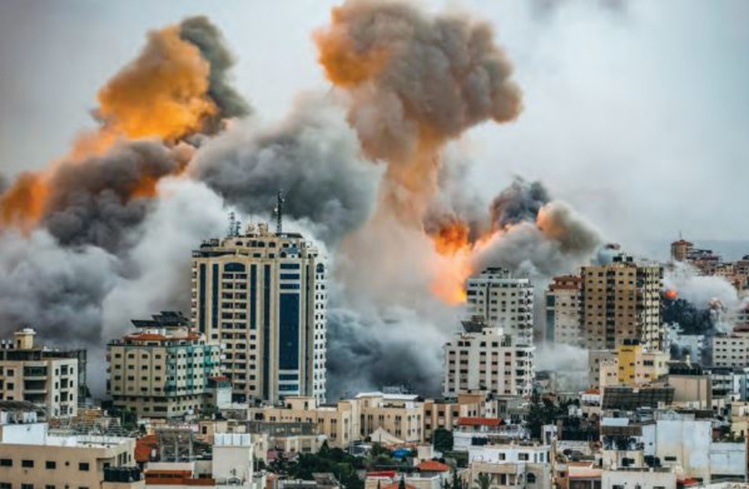  FIRE AND smoke rise during Israeli airstrikes in the Gaza Strip this week. Iran and its genocidal proxy armies, such as Hamas and Hezbollah, must be crushed, the writer asserts. (credit: ATIA MOHAMMED/FLASH90)
