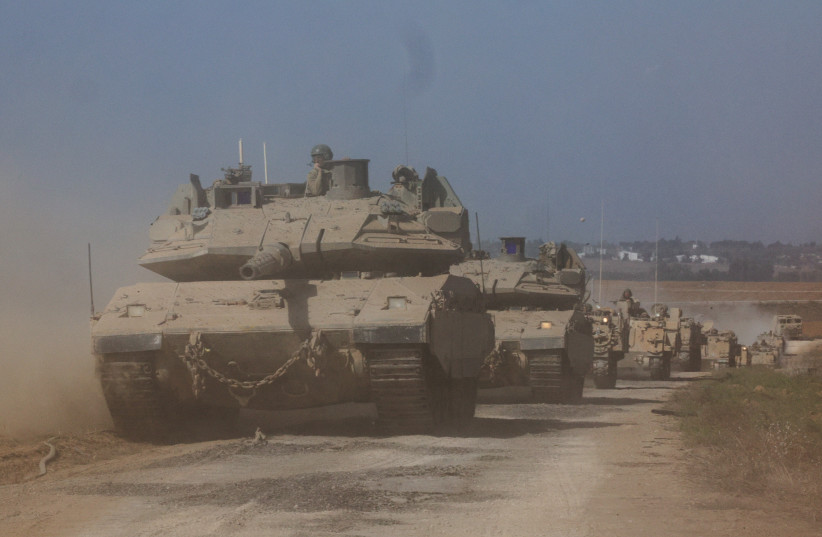  Israeli tanks and military vehicles take position near Israel's border with the Gaza Strip, in southern Israel, October 13, 2023. (credit: REUTERS/VIOLETA SANTOS MOURA)