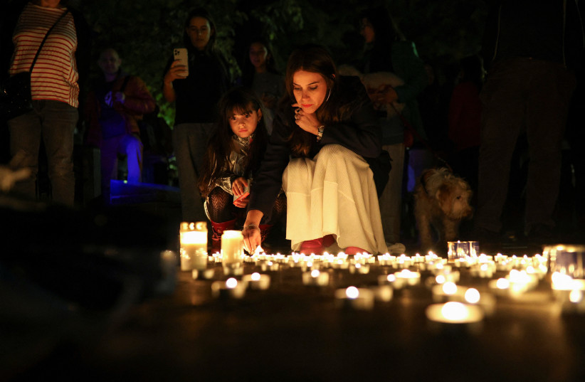  People attend a candlelight vigil for remembrance and solidarity with Israel in front of the Monument of the Salvation of the Bulgarian Jews in Sofia, Bulgaria, October 10, 2023.  (credit: REUTERS/SPASIYANA SERGIEVA)