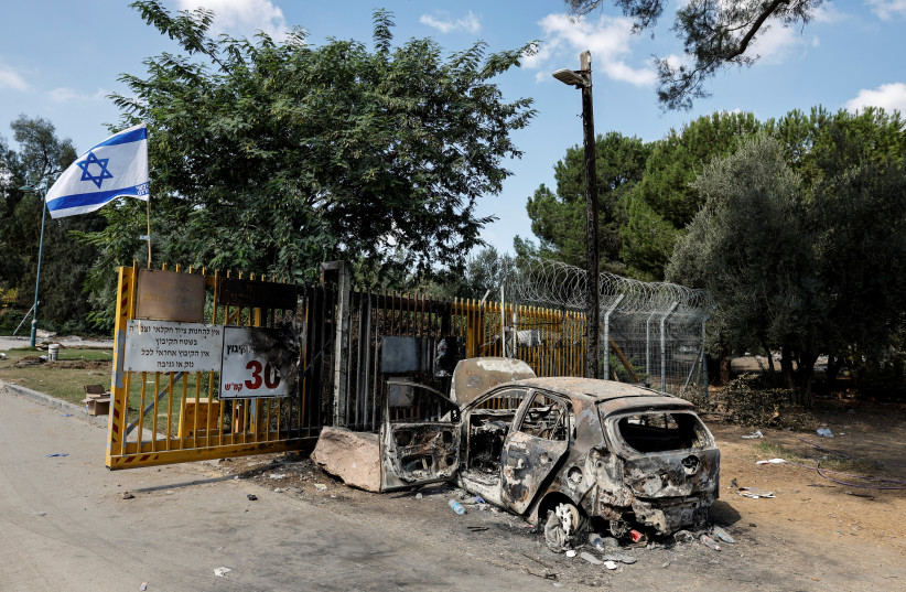  A burnt car is seen at the gate to Kibbutz Beeri, following a mass infiltration by Hamas gunmen from the Gaza Strip, in southern Israel, October 13, 2023. (credit: REUTERS/AMIR COHEN)