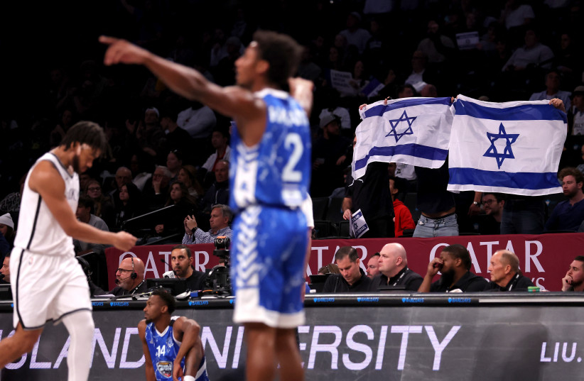  Oct 12, 2023; Brooklyn, NY, USA; Fans hold up Israeli flags during the fourth quarter between the Brooklyn Nets and Maccabi Ra'anana at Barclays Center.  (credit: BRAD PENNER/USA TODAY SPORTS VIA REUTERS)