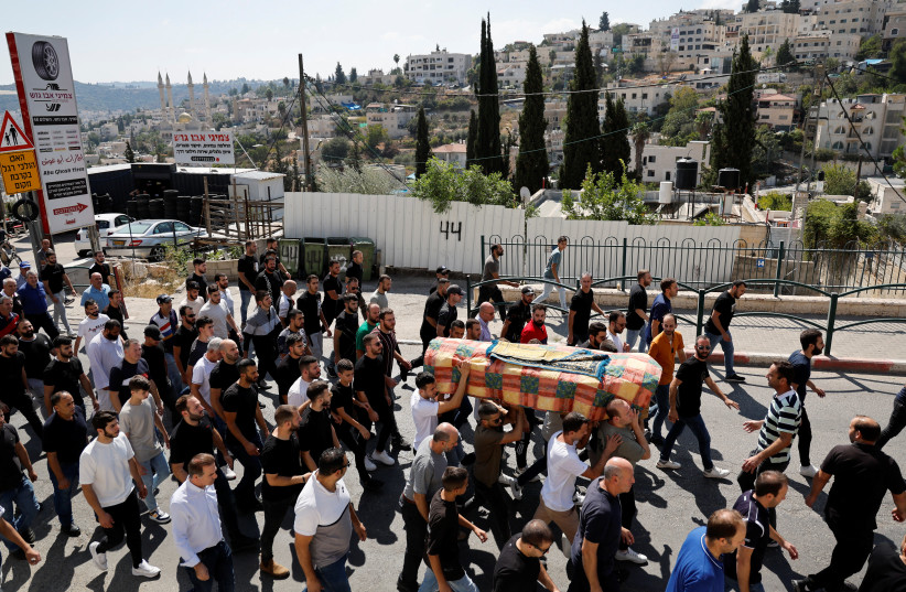  People carry a coffin, as friends and family mourn the victim of a Hamas rocket attack in the Israel-Arab village of Abu Ghosh, Israel October 14, 2023. (credit: REUTERS/AMMAR AWAD)