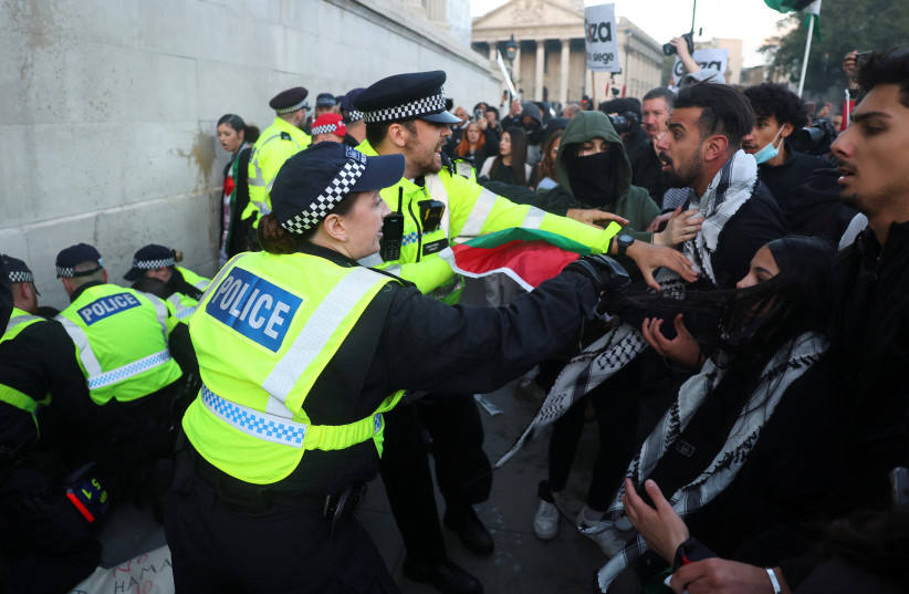  Police officers clash with demonstrators as they protest in solidarity with Palestinians, amid the ongoing conflict between Israel and the Palestinian terrorist group Hamas, in London, Britain, October 14, 2023.  (credit: REUTERS/TOBY MELVILLE)