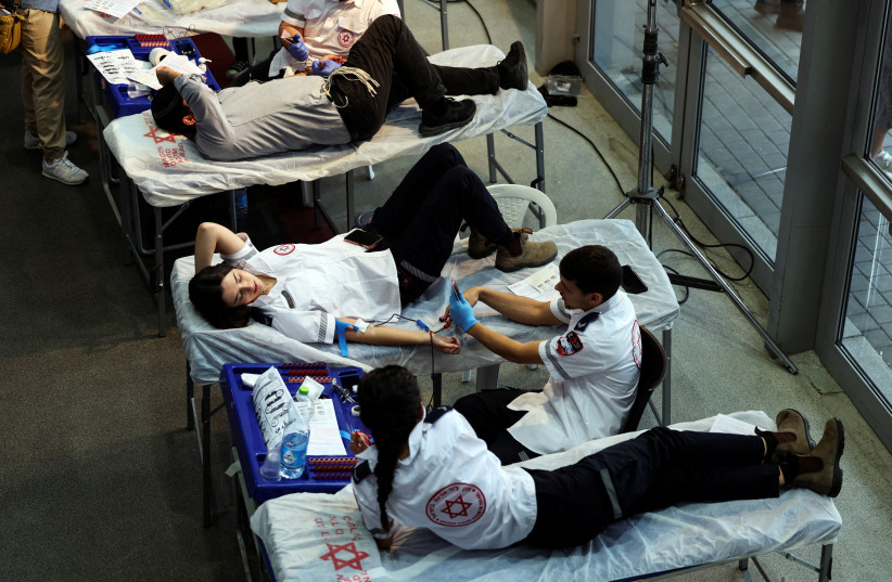  People donate blood as part of a blood-drive following a mass-rampage by armed Palestinian infiltrators into Israel, in Jerusalem October 9, 2023.  (credit: REUTERS/Ronen Zvulun)