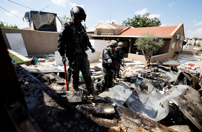 Israeli police explosive experts survey the remains of a private house after it was hit by a rocket launched from the Gaza Strip into Israel, in Sderot, southern Israel October 15, 2023. (credit: REUTERS/AMIR COHEN)