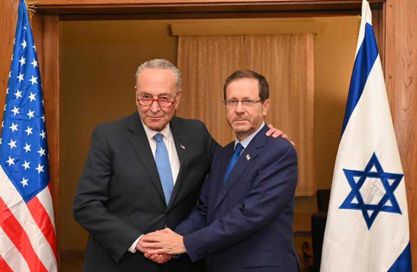  Majority Leader of the US Senate Chuck Schumer (left) with President Isaac Herzog. October 15, 2023 (credit: CHAIM TZACH/GPO)