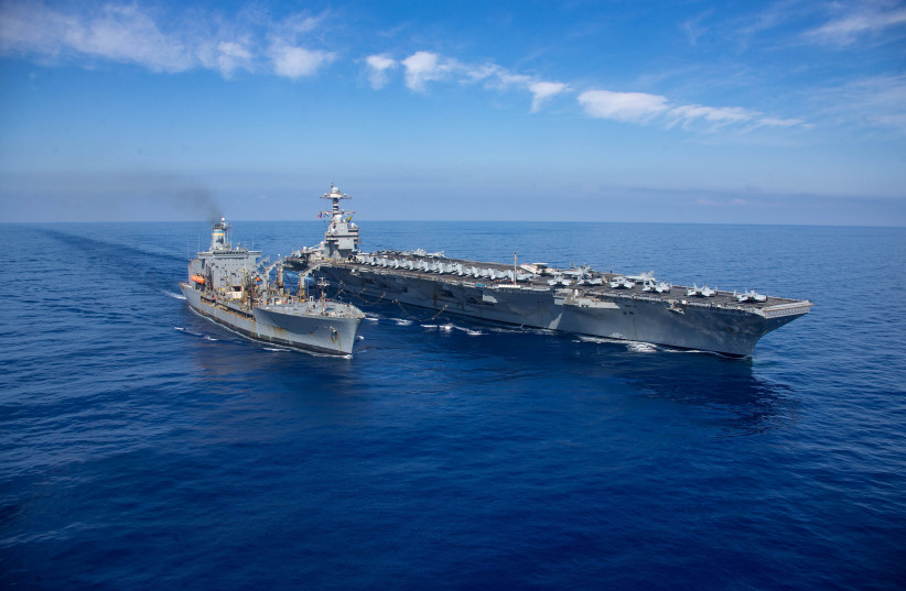  USS Gerald R. Ford steams alongside USNS Laramie (T-AO-203) during a fueling-at-sea in the eastern Mediterranean Sea, as a scheduled deployment in the U.S Naval Forces Europe area of operations, deployed by U.S. Sixth Fleet to defend U.S, allied, and partners interests, in this photo taken on Octob (credit: US Naval Forces Central Command / US 6th Fleet / Handout via REUTERS)