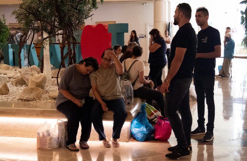  Survivors of Hamas attack on southern Israel, embrace after being evacuated to a hotel in Ein Bokek, Israel October 11, 2023. (credit: REUTERS)