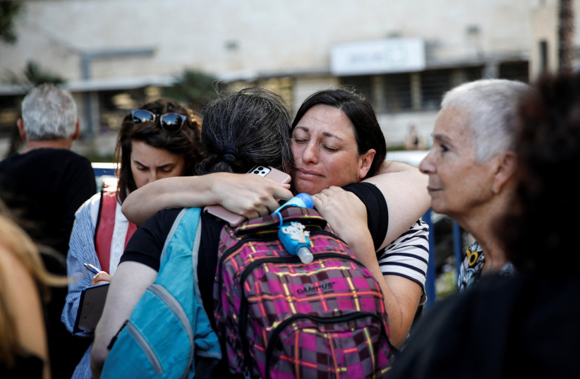  Women embrace as U.S. nationals and their immediate family members wait before leaving Israel on a ship headed for Cyprus, amid the ongoing conflict between Israel and the Palestinian Islamist group Hamas, in Haifa, Israel, October 16, 2023. (credit: REUTERS/SHIR TOREM)