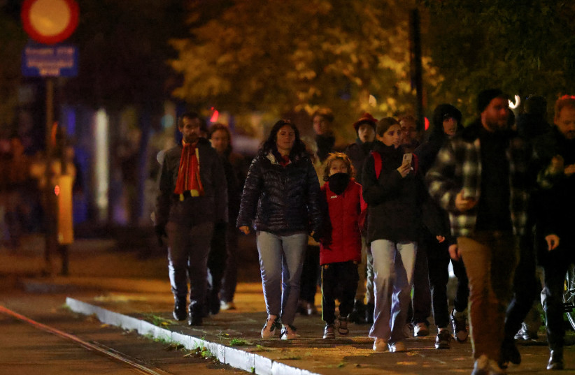  People walk outside King Baudouin Stadium after the match between Belgium and Sweden was suspended following a shooting in Brussels, Belgium, October 17, 2023. (credit:  REUTERS/JOHANNA GERON)