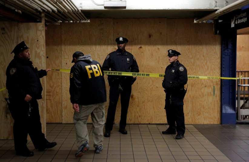 A member of the FBI enters the crime scene beneath the New York Port Authority Bus Terminal following an attempted detonation during the morning rush hour, in New York City, New York, U.S., December 11, 2017.