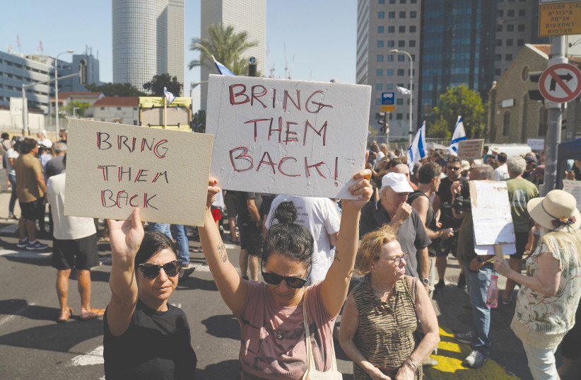 DEMONSTRATORS IN Tel Aviv call for the return of loved ones who were taken as hostages into Gaza by Hamas terrorists. (credit: JANIS LAZIANS/REUTERS)