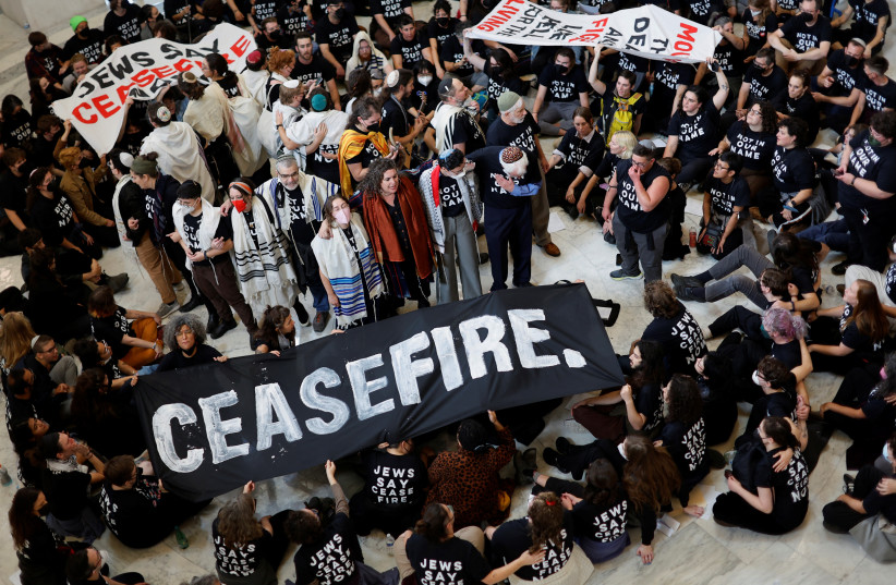 Protesters calling for a cease fire in Gaza and an end to the Israel-Hamas conflict occupy the rotunda of the Cannon House office building with a civil disobedience action on Capitol Hill in Washington, US, October 18, 2023. (credit: JONATHAN ERNST/REUTERS)