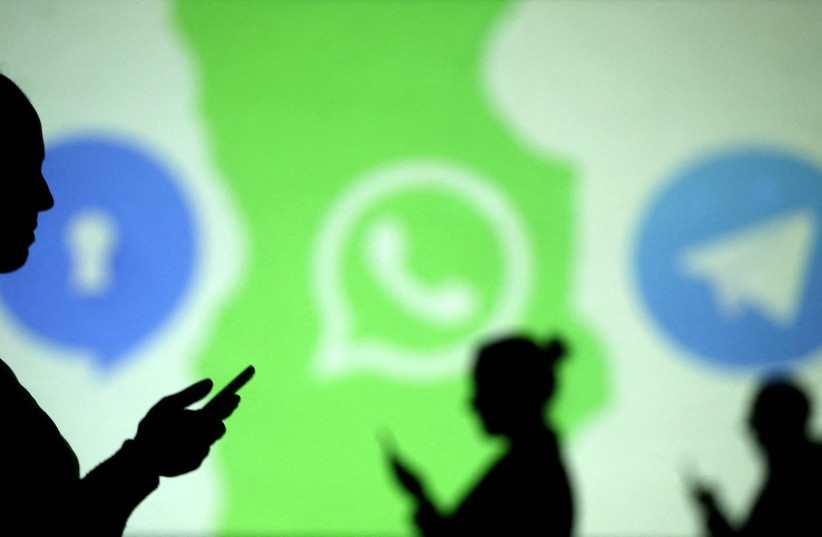  Silhouettes of mobile users are seen next to logos of social media apps Signal, Whatsapp and Telegram projected on a screen in this picture illustration taken March 28, 2018. (credit: REUTERS/DADO RUVIC/ILLUSTRATION/FILE PHOTO)