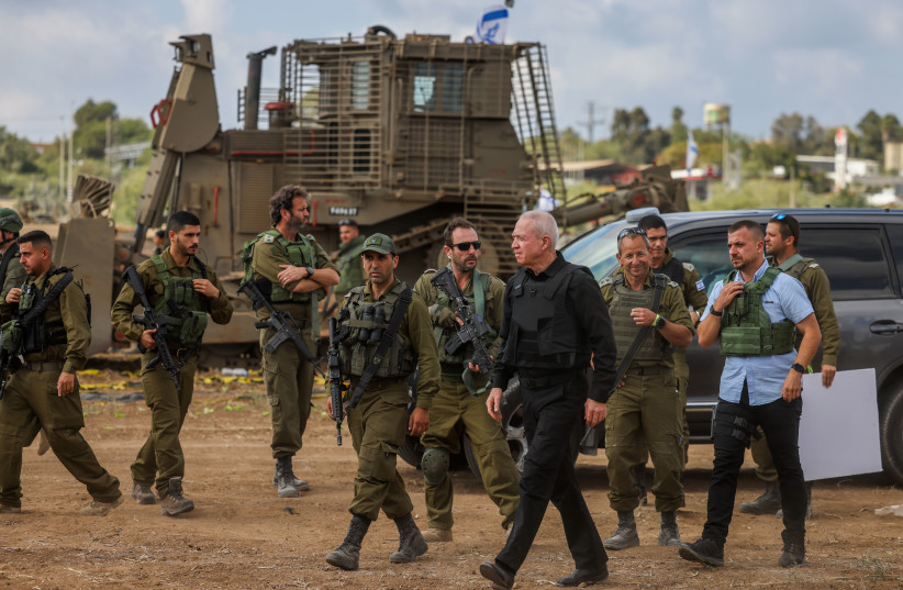  Defense Minister Yoav Gallant speaks with Israeli soldiers at a staging area not far from the Israeli-Gaza border, October 19, 2023 (credit: Chaim Goldberg/Flash90)